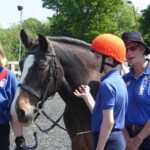 Rider with helpers waiting to mount