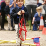 Child carrying horses head collar